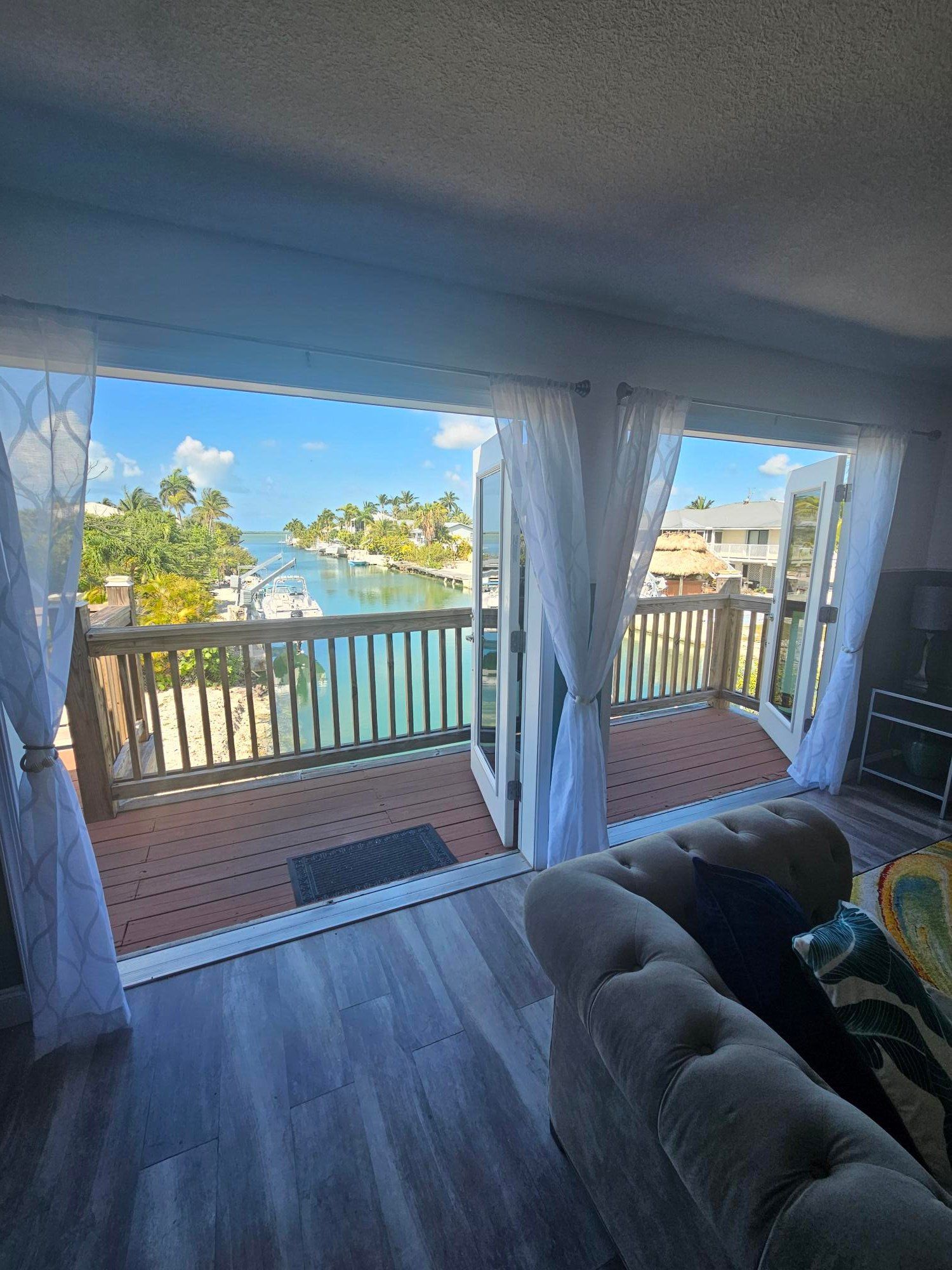 French doors from the main bedroom opening onto the balcony and the canal